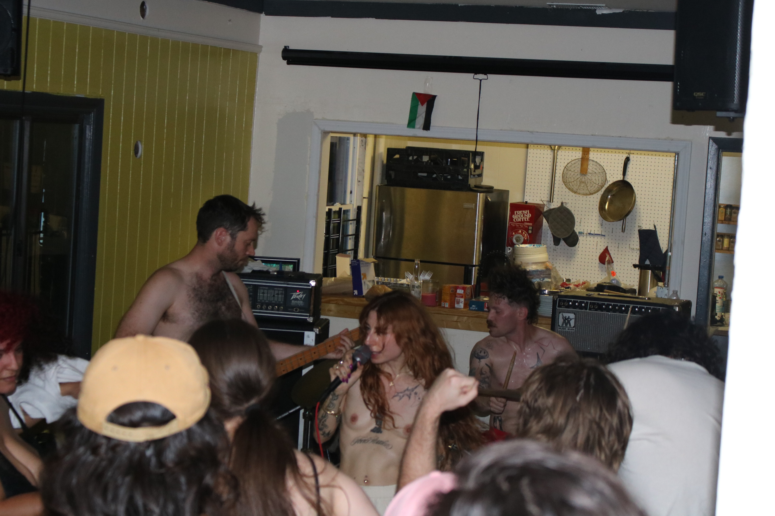 a photo of the band Muscle playing s show shirtless in atlanta, ga
